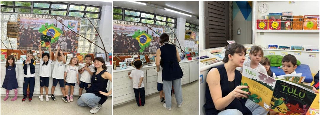 Crianças e professora diante do painel Brasil em Abril na biblioteca e leitura do livro Tulu