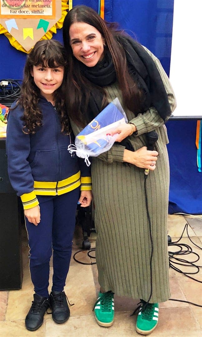 Roberta Negrini, do Movimento Eu visto o bem, posa abraçada a uma aluna