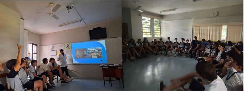 Aula temática do Projeto Promovendo a Tolerância, com slide sobre Auschwitz e alunos em roda